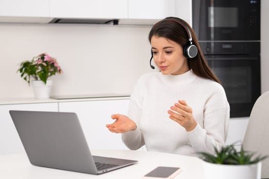 Brunette working at home via the internet. Online personal development, self improvement and goal setting courses concept.