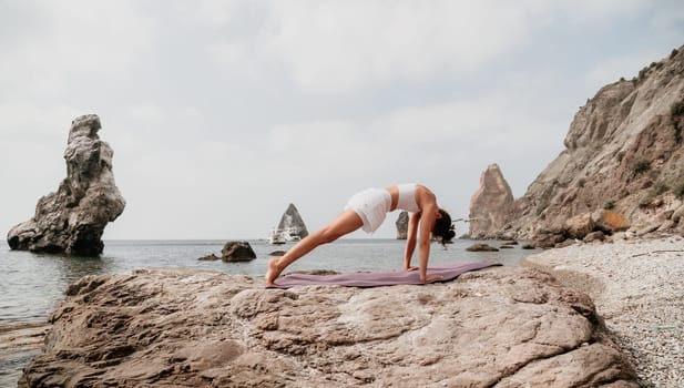 Fitness woman sea. Outdoor workout on yoga mat in park near to ocean beach. Female fitness pilates yoga routine concept. Healthy lifestyle. Happy fit woman exercising with rubber band in park.