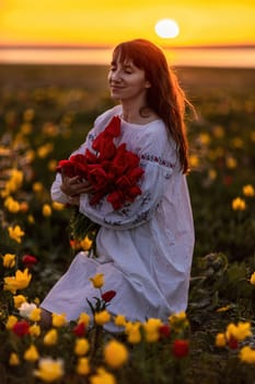 Woman field tulips sunset. Woman against sunset and wild tulip flowers, natural seasonal background. Multi-colored tulips Tulipa schrenkii in their natural habitat are listed in the Red Book