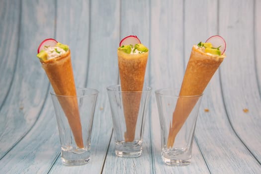 Brick cone with tuna sauce, mayonnaise, avocado and radish slice, High quality photo