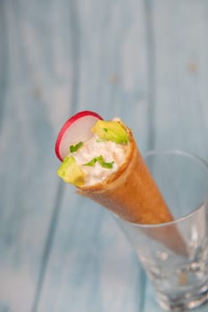 Brick cone with tuna sauce, mayonnaise, avocado and radish slice, High quality photo