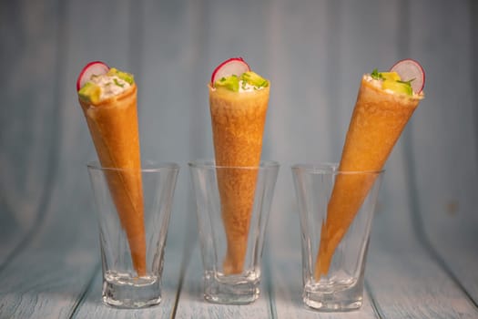 Brick cone with tuna sauce, mayonnaise, avocado and radish slice, High quality photo