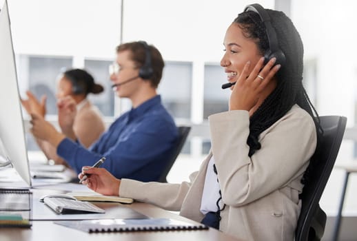 Woman, call center and writing notes, smile in office and working on customer service in workplace. Telemarketing, talking and happiness of person, female sales agent or consultant consulting online