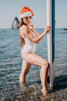 Close up shot of happy young caucasian woman looking at camera and smiling. Cute woman portrait in bikini posing on a volcanic rock high above the sea