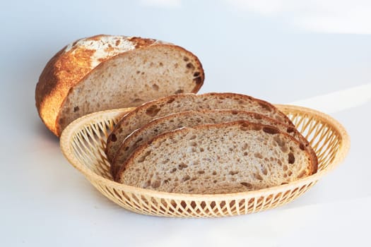 A loaf of bread highlighted on a white background. View from above. He was lying flat. Creative bread layout Sliced bread on a white background. Slices of bread, top view.