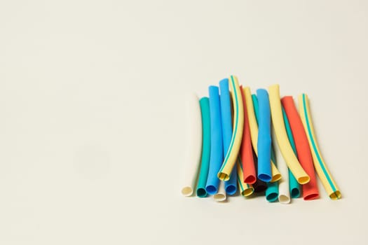 Multicolored shrink tube on a white background tubes of different colors