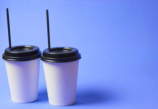 Paper coffee container with Black Lid on blue background white coffee paper cup with black Lid takeaway Coffee