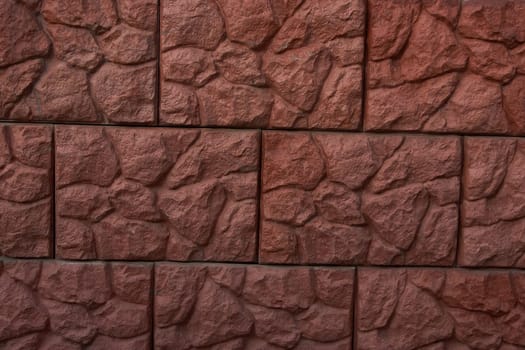 Old brown stone wall Close-up Background of stone tiles with detailed natural texture.