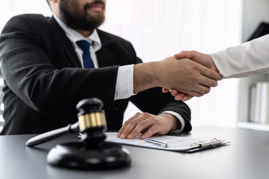 Closeup lawyer or attorneys colleagues handshake after successful legal discussing on contract agreement for lawsuit to advocate resolves dispute in court ensuring trustworthy partner. Equilibrium