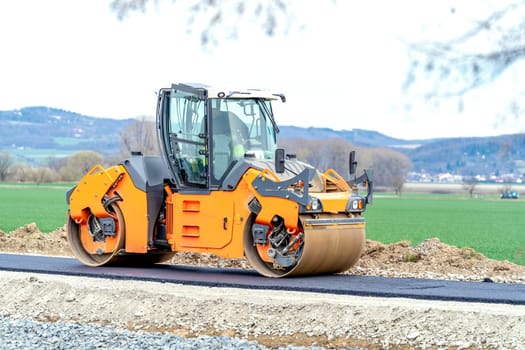 roller for asphalt compaction during the construction of a new road and traffic communication. High quality photo