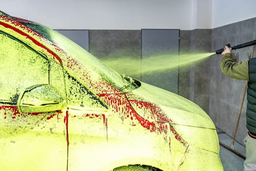 wash cars with green active foam in the garage. High quality photo