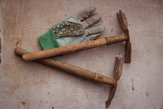 Tools for farming hoe chopper and mittens. On a concrete background. Harvest and plant care.