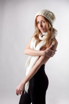 Portrait of young slim girl posing in winter clothes, close-up