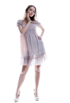 Attractive young woman posing in motley sarafan, isolated on white