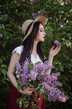 A fashionable girl with dark hair, a spring portrait in lilac tones in summer. Bright professional makeup