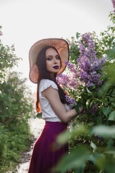 A fashionable girl with dark hair, a spring portrait in lilac tones in summer. Bright professional makeup