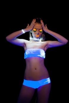 Portrait of energetic girl with UV make-up posing at disco