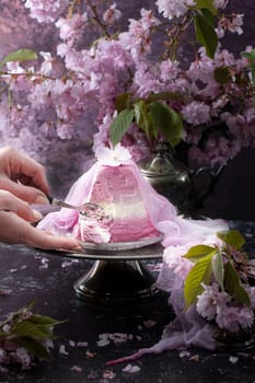 Traditional Easter Orthodox curd cake with blueberry. Traditional Easter curd cake with sakura flowers, woman decorating food, High quality photo