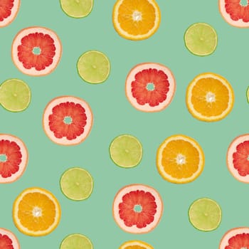 Sliced pieces of orange, lime and grapefruit on a green background. Seamless pattern