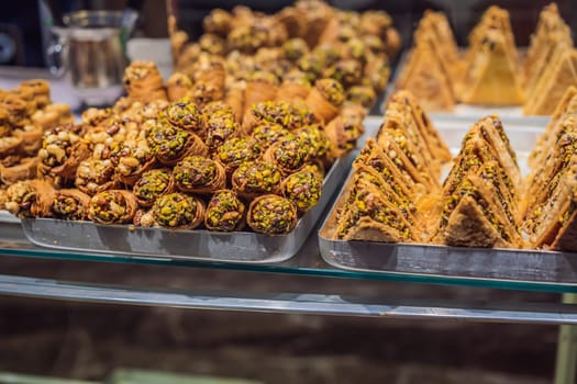 Traditional oriental sweet pastry cookies, nuts, dried fruits, pastilles, marmalade, Turkish desert with sugar, honey and pistachio, in display at a street food market.