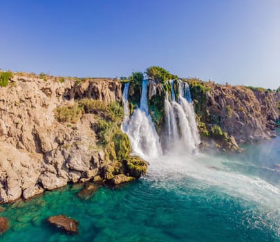 Lower Duden Falls drop off a rocky cliff falling from about 40 m into the Mediterranean Sea in amazing water clouds. Tourism and travel destination photo in Antalya, Turkey. Turkiye