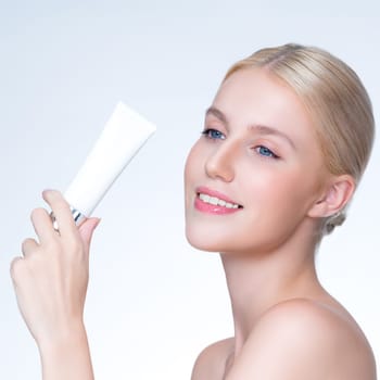 Closeup personable beautiful perfect natural skin woman hold mockup tube moisturizer cream for skincare treatment product advertising expressive facial and gesture expression in isolated background.