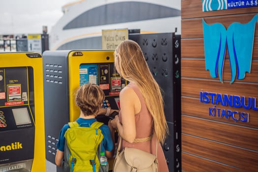 August 13, 2022: Istanbul Turkey. Mom and son use istanbul cards. Istanbul Card is a top up public transportation card for all the public vehicles in the city. Istanbul Kart means Istanbul Card in Turkish.