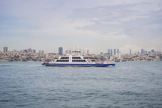 Istanbul, Turkey August 13, 2022: Muslim architecture and water transport in Turkey - Beautiful View touristic landmarks from sea voyage on Bosphorus.