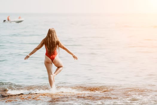 Woman sea yoga. Back view of free calm happy satisfied woman with long hair standing on top rock with yoga position against of sky by the sea. Healthy lifestyle outdoors in nature, fitness concept.