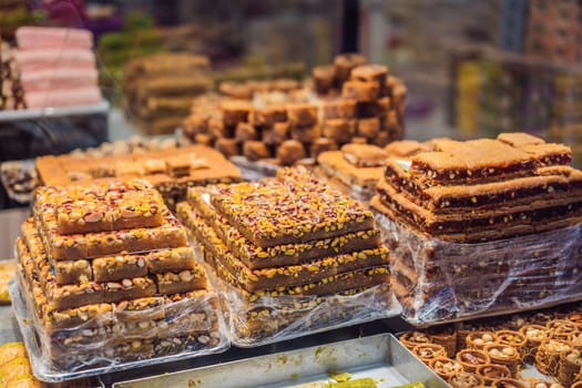 Traditional oriental sweet pastry cookies, nuts, dried fruits, pastilles, marmalade, Turkish desert with sugar, honey and pistachio, in display at a street food market.