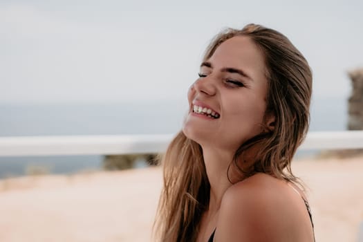 Happy woman portrait in cafe. Boho chic fashion style. Outdoor photo of young happy woman with long hair, sunny weather outdoors sitting in modern cafe