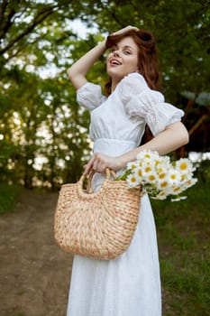 portrait of a beautiful red-haired woman with a wicker basket in her hands, holding her hair with her hand, walks in the park. High quality photo