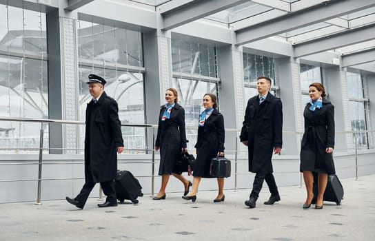 Airplane crew in uniform is going to the work together.