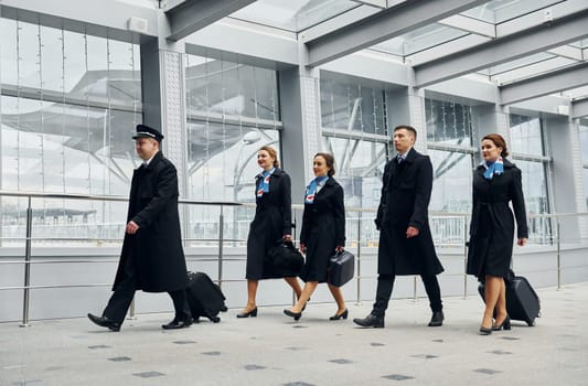 Airplane crew in uniform is going to the work together.