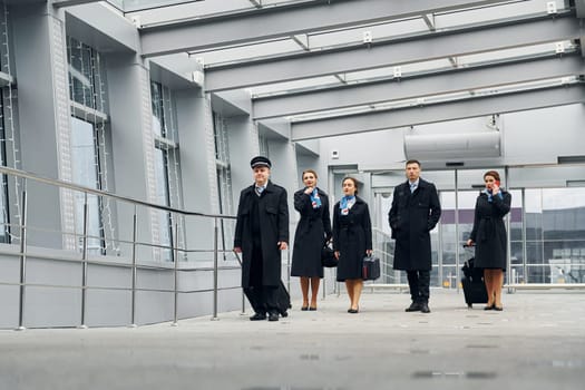 In uniform. Airplane crew in uniform is going to the work together.