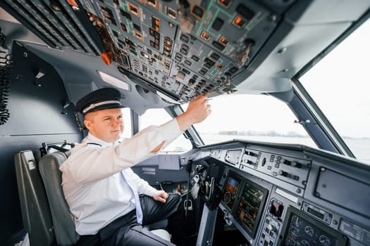 Control of the flight. Pilot on the work in the passenger airplane. Preparing for takeoff.