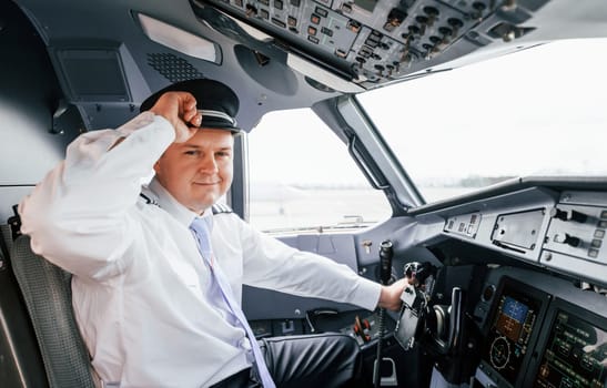 Pilot on the work in the passenger airplane. Preparing for takeoff.