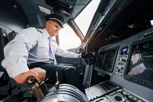 Pilot on the work in the passenger airplane. Preparing for takeoff.