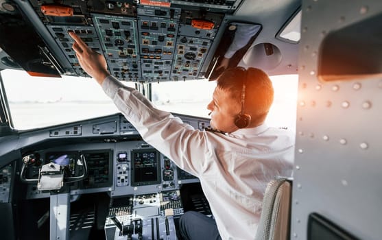 Control of the flight. Pilot on the work in the passenger airplane. Preparing for takeoff.