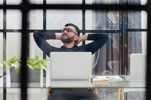 Middle-aged man working on laptop in office