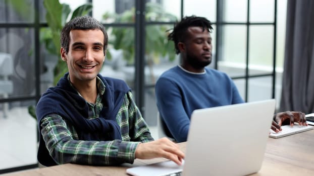 Young multiethnic businessmen working at the negotiating table