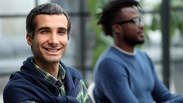 Close-up portrait of handsome successful businessman at office