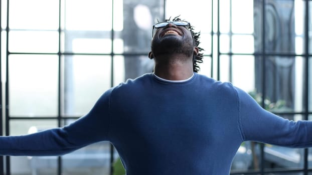 young businessman spread his arms to the side in the office