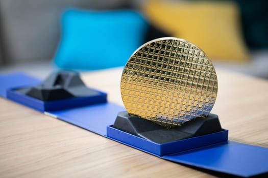 Close-up of the processor standing on the table. Presentation of computer parts. Computer hardware ready for replacement and installation on the device. A yellow and blue pad is visible in the blurry background.