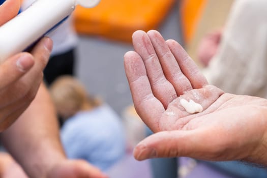 Close up man hand applies magnesium on his hand before training in the gym.