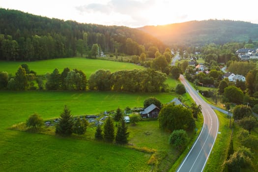 Majestic sunset in the countryside, Small village surrounded by hills with lush trees, Dolni Morava, Czech Republic