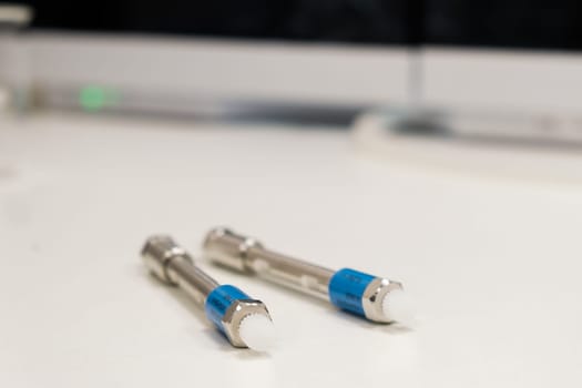 HPLC 50 mm columns on the table in the laboratory. Fast high performance liquid chromatography analysis in a chemical and microbiological laboratory. Clinical, toxicological and forensic analysis.