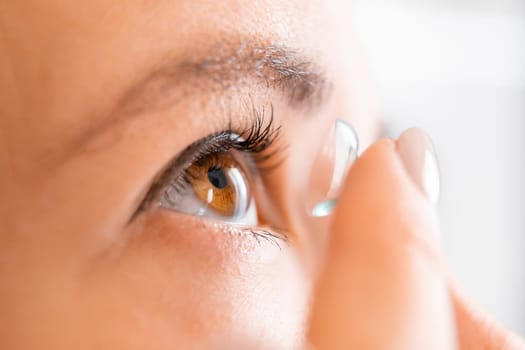 Woman putting contact lens for better vision. Opthalmology medicine and health