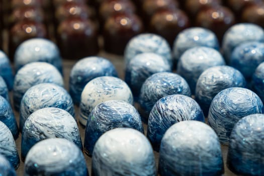 Exclusive handmade chocolate candy covered with blue glaze.