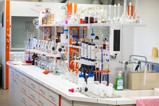 Well equipped chemical laboratory with glassware, pipettes, flasks and bottles. The workplace for research work. November 2021, Prague, Czech Republic.